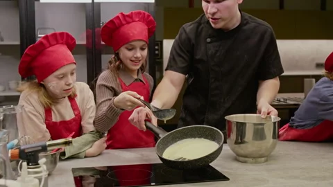 Children Learning to Cook and Pouring Batter in Cooking Class Stock-Footage 339500645