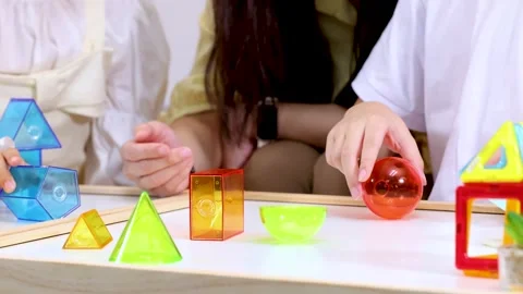 Children Learning Geometry with Colorful Blocks in Classroom Stock Footage 321672658