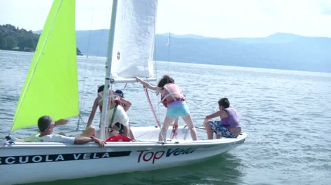 Children learning how to sail on small sailing boat Stock Footage 36783954