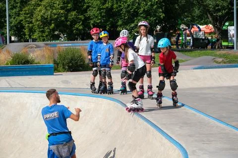 Children Learning Inline Skating at Skatepark With Coach Stock Photos