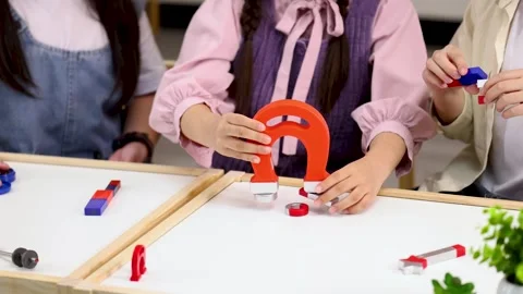 Children Learning Physics with Horseshoe and Bar Magnets in Science Class Stockbeeldmateriaal 328346107