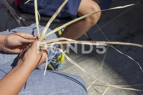Children learning to plait vegetable fibers Stock Photos
