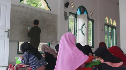 Children learning the Quran at a mosque in a small village Stock Footage 269707923