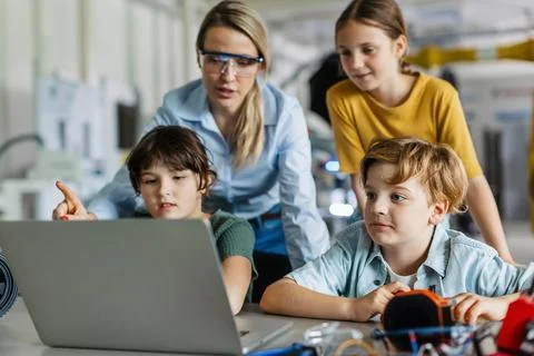 Children learning robotics in Elementary school. Young students programming Stock Photos