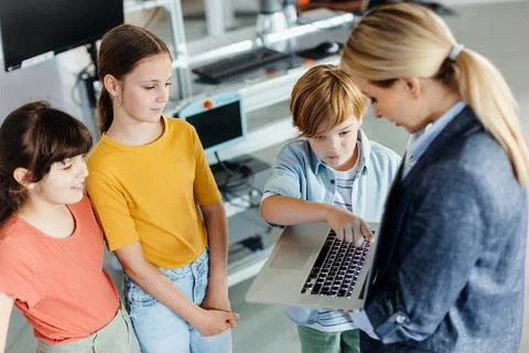Children learning robotics in Elementary school. Young students building robot Stock Photos