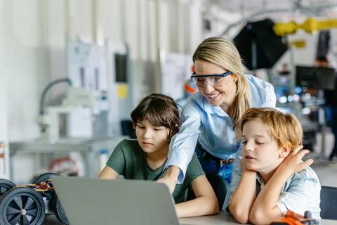 Children learning robotics in Elementary school. Young students programming Stock Photos