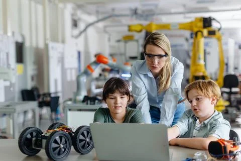 Children learning robotics in Elementary school. Young students programming Stock Photos