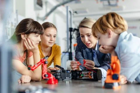 Children learning robotics in Elementary school. Young students building robot Stock Photos