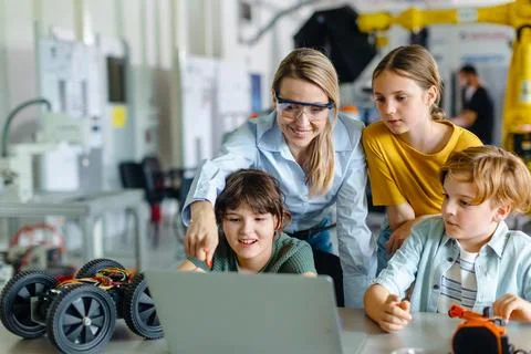 Children learning robotics in Elementary school. Young students programming Stock Photos