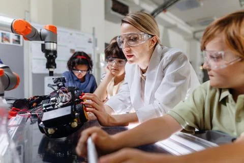 Children learning robotics in Elementary school. Young students building robot Stock Photos