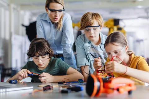 Children learning robotics in Elementary school. Young students building robot 写真素材