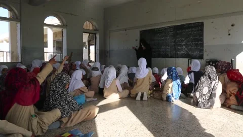 Children learning in a school destroyed by the war Stock Footage 159434699