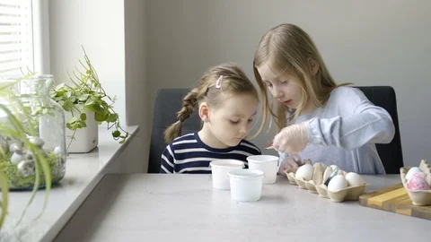 Children learning the spring tradition of dyeing Easter eggs. Stock Footage 126842391