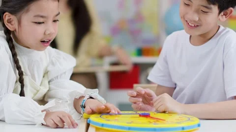 Children Learning to Tell Time with Toy Clock in Classroom Stock Footage 330102066