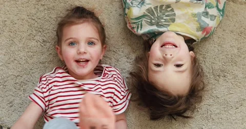 Children lie on their backs and laugh Stock Footage 149294322
