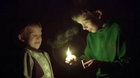 Children light matches in the dark Stock Footage