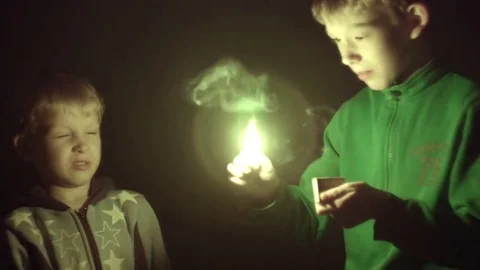 Children light matches in the dark Stock Footage 76837119