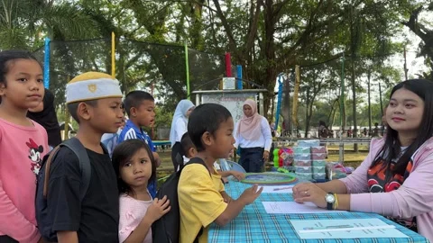 Children Lining Up at Park Event Table Stock Footage 326629224