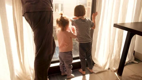 Children look out the window with their father Video stock 131002949