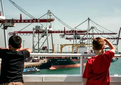 Children looking at container terminal at Dunkirk, France. Major route for im Stock Photos