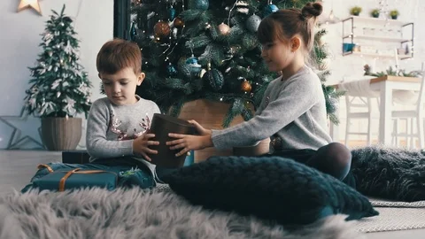 Children looking on xmas gift boxes Stock Footage 120837295