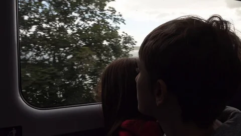 Children lookout of a window on a train Stock Footage 94419983