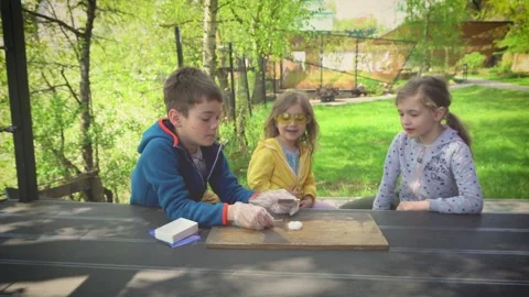 Children make an experiment with burning dry alcohol. Stock Footage 154929071
