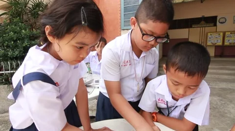 Children make paper mache at Elementary School. Bangkok Thailand Stock Footage 64457422