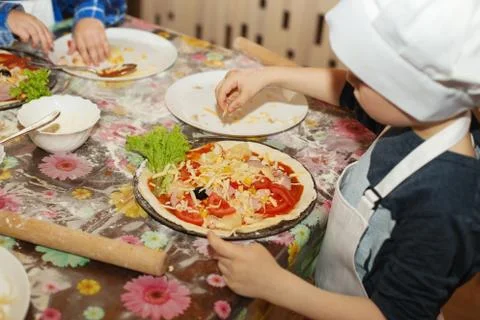 Children make pizza. Master class for children on cooking Italian pizza. Youn Stock Photos