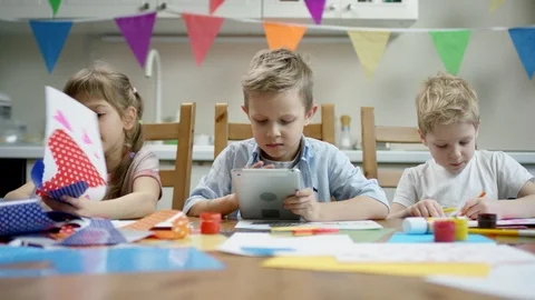 Children make preparation for fiesta while one of them play in the tablet Stock Footage 107985872