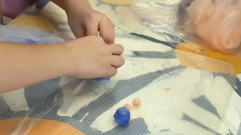 Children make a rabbit shape out of wool, children's master class on felting a t Stock-Footage 306570686