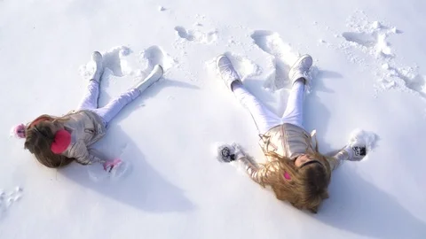 Children make winter angel. Theme Christmas holidays winter new year. Happy Stock Footage