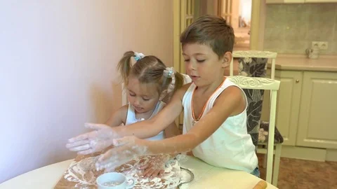 Children Making the dough for pizza in light kitchen Stock Footage 124635119