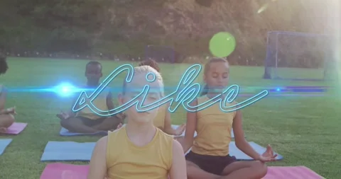 Children meditating on grass with glowing Like text animation overlay Stock Footage 328411284
