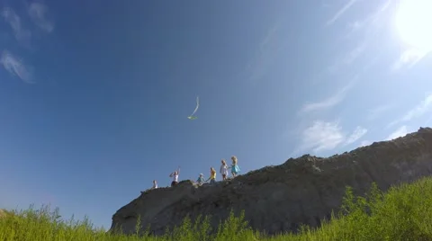 Children from the mountain run with a kite. Video stock 53466348