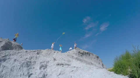Children from the mountain run with a kite. Stock-Footage 53466378
