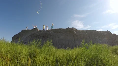 Children from the mountain run with a kite. Stock-Footage 53466585