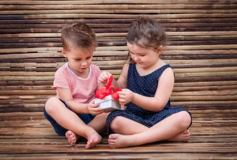 Children open a gift box Stock Photos