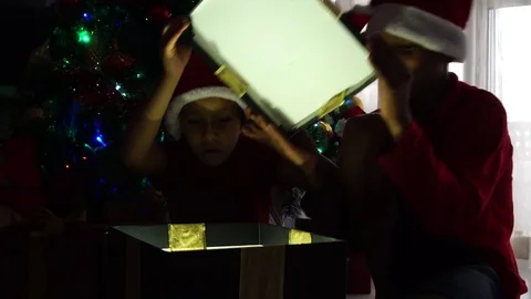 Children opening a big box and looking for a present in christmas time at home Stock Footage 81546071