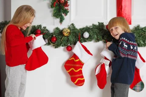 Children opens Christmas stocking Stock Photos