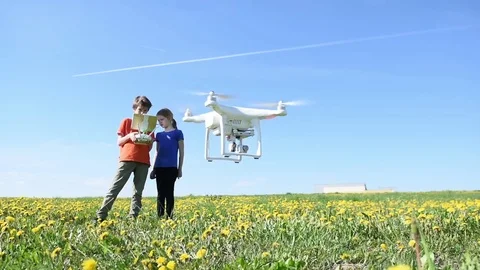 Children operating of flying drone at sunset Stock Footage 84213945