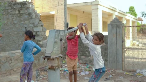 Children Operating Water Pump Stock Footage 322158504