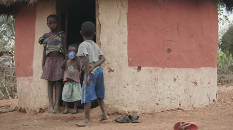 Children outside dirt hut 動画素材 59796864