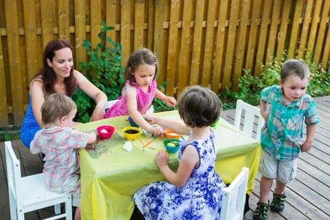 Children Outside Dyeing Easter Eggs Stock Photos