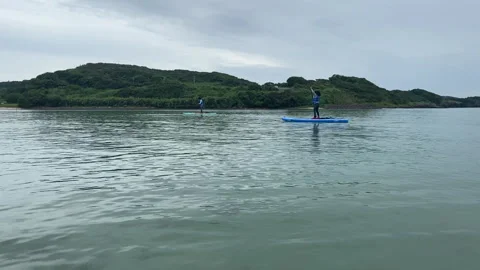 Children Paddleboarding in Clear Ocean Waters, Sasebo City Stock Footage 247420977