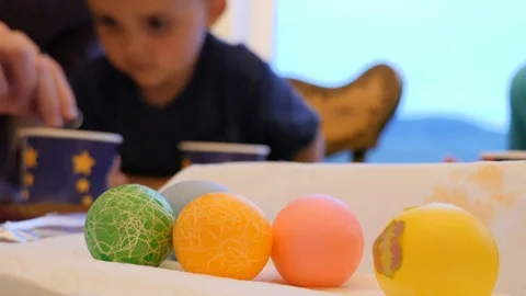 Children paint and decorate easter eggs as a family Video stock 89651110