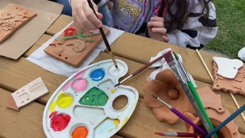 Children paint clay drawings with multi colored paints. This is pleasure. Stock Footage 239019585