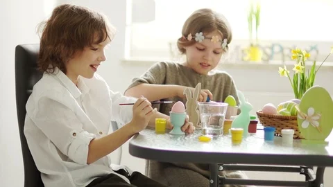 Children paint Easter eggs at home. Easter traditions Stock Footage 87504156