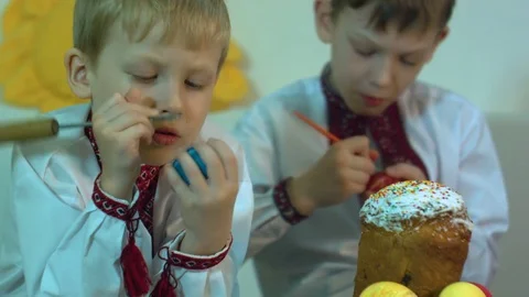 Children paint traditional Easter eggs Stock Footage 74832483