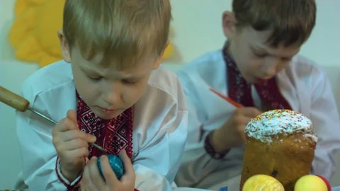 Children paint traditional Easter eggs Stock Footage 74833354